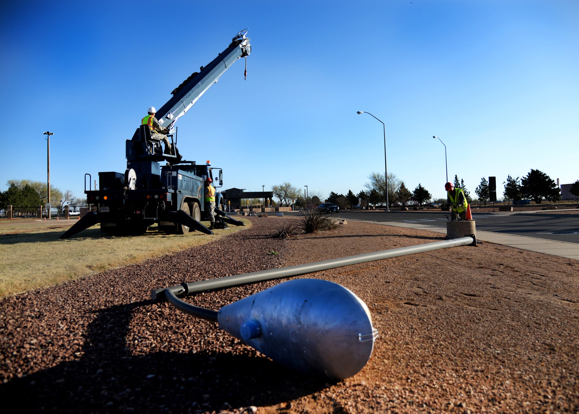 Members of the 27th Special Operations Civil Engineer Squadron remove lights in anticipation for the addition of an AC-130H Spectre gunship to the Air Park on April 5, 2014 at Cannon Air Force Base, N.M. The gunship had to seamlessly make its way from the flightline, all the way to the main gate. (U.S. Air Force photo/Airman 1st Class Chip Slack)
