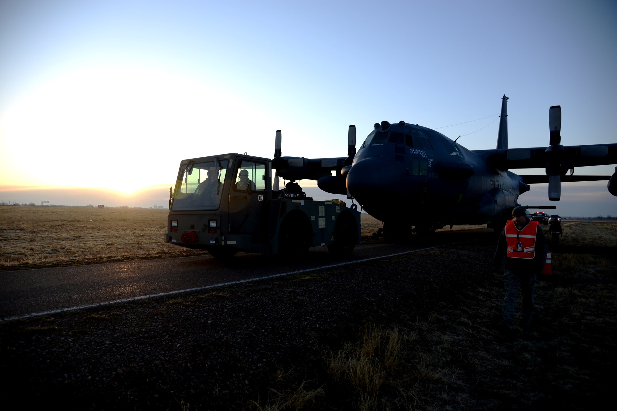 A newly retired AC-130H Spectre gunship, aptly named the “Gravedigger,” is towed along the back roads on April 6, 2014 at Cannon Air Force Base, N.M. The historical aerial asset will be the newest addition to the Air Park, to be memorialized for generations to come. (U.S. Air Force photo/Airman 1st Class Chip Slack)