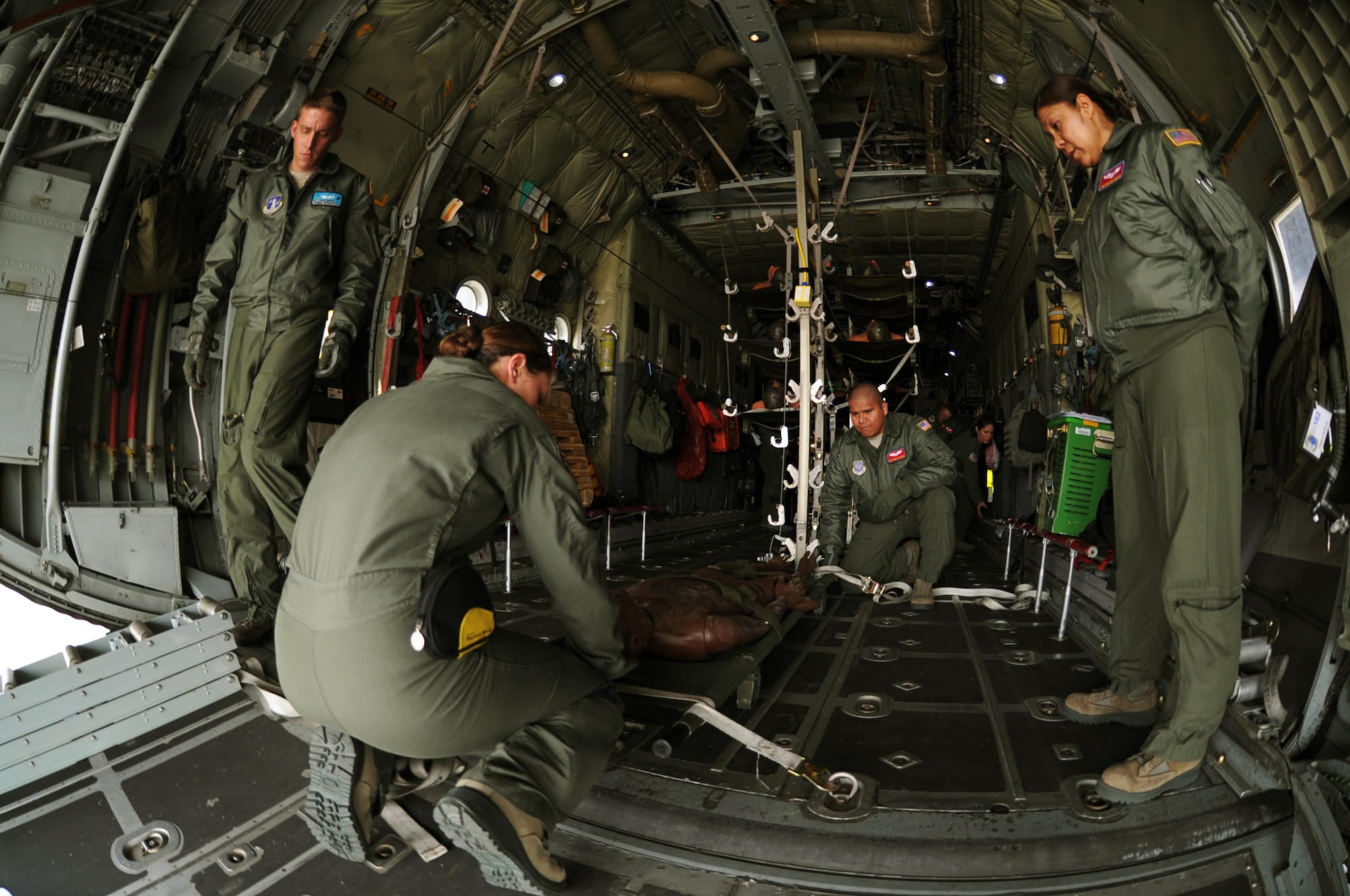 Active duty and Air Force Air National Guard Aeromedical Evacuation members train on a C-130 during a national disaster exercise, Ultimate Caduceus 2014 March 31, 2014. During Ultimate Caduceus, part of the Federal Emergency Management Agency?s National Capstone Exercise, AE members provided medical support, processed and transferred patients. By interacting and working closely with our federal, state and joint partners, Airmen in Utlimate Caduceus 14 are able to develop refinements to processes and procedures that can potentially enhance the effectiveness of real-world relief operations. The aeromedical teams were comprised of more than 18 AE crew members from Pope Army Airfield, N.C., Scott AFB, Ill., and Cheyenne ANG base, Wyo. (U.S. Air Force photo/ Staff Sgt. Stephenie Wade)