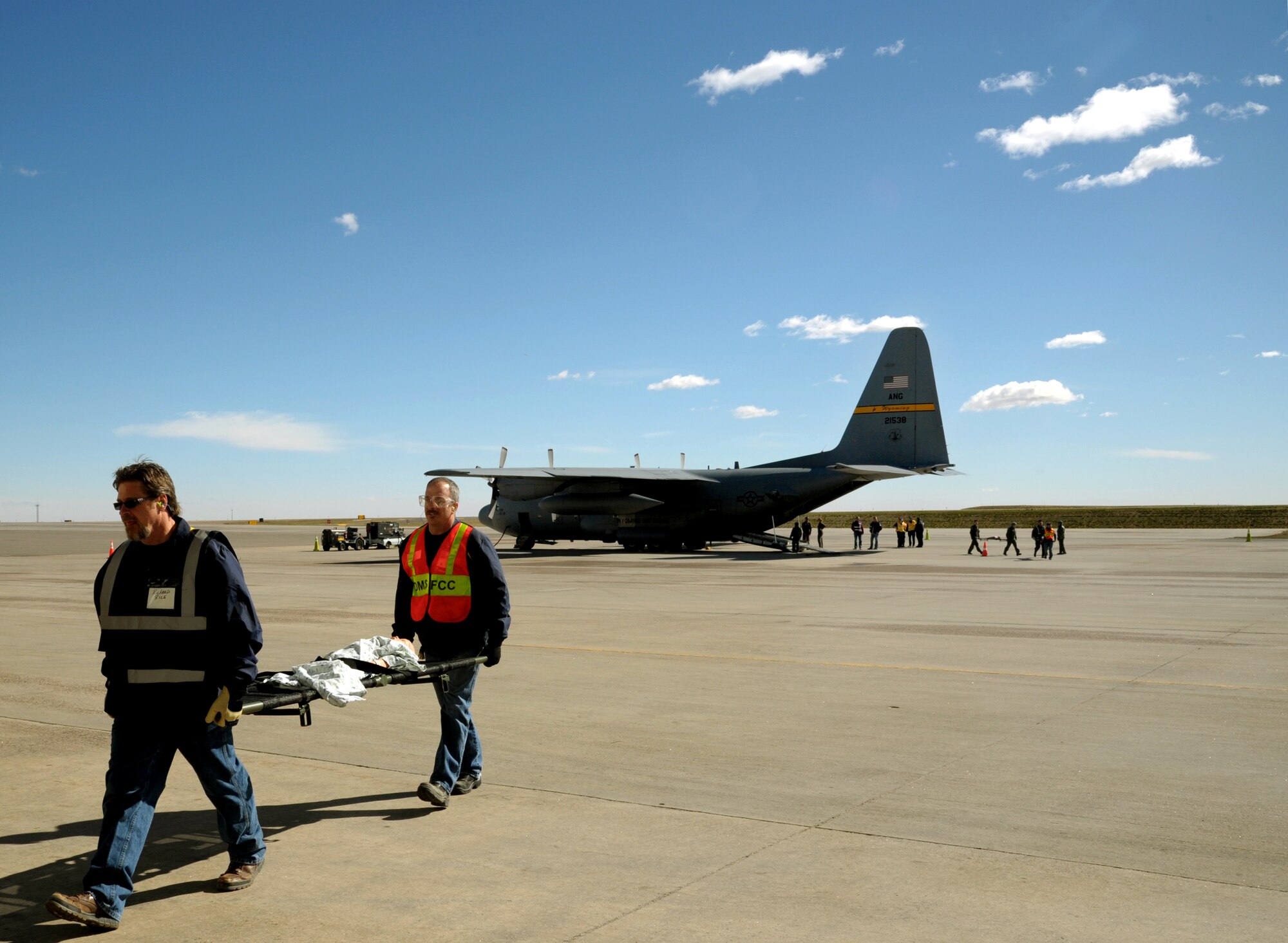 Civilian litter carry volunteers carry simulated patients to an aircraft during a national disaster exercise, Ultimate Caduceus 2014, at Denver, Colo., March 31, 2014. Both technicians are assigned to the 375th Aeromedical Evacuation Squadron, Scott AFB, Il. During Ultimate Caduceus, part of the Federal Emergency Management Agency’s National Capstone Exercise, AE members provided medical support, processed and transferred patients. The aeromedical teams were comprised of more than 18 AE crew members from Pope Army Airfield, N.C., Scott AFB, Ill., and Cheyenne ANG base, Wyo. (U.S. Air Force photo/ Staff Sgt. Stephenie Wade)