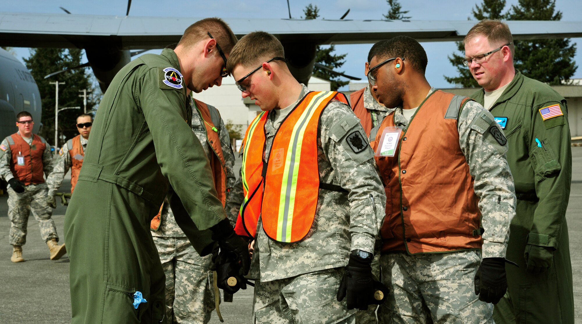 Staff Sgt. Bryan Long, 43rd Aeromedical Evacuation Squadron, teaches U.S. Army members how to load and carry a litter during a national disaster exercise, Ultimate Caduceus 2014, at Joint Base Lewis-McChord, Wash., April 1, 2014. During Ultimate Caduceus, part of the Federal Emergency Management Agency's National Capstone Exercise, AE members provided medical support, processed and transferred patients. By interacting and working closely with our federal, state and joint partners, Airmen in Ultimate Caduceus 14 are able to develop refinements to processes and procedures that can potentially enhance the effectiveness of real-world relief operations. The aeromedical teams were comprised of more than 18 AE crew members from Pope Army Airfield, N.C., Scott Air Force Base, Ill., and Cheyenne ANG base, Wyo. (U.S. Air Force photo/ Staff Sgt. Stephenie Wade)


