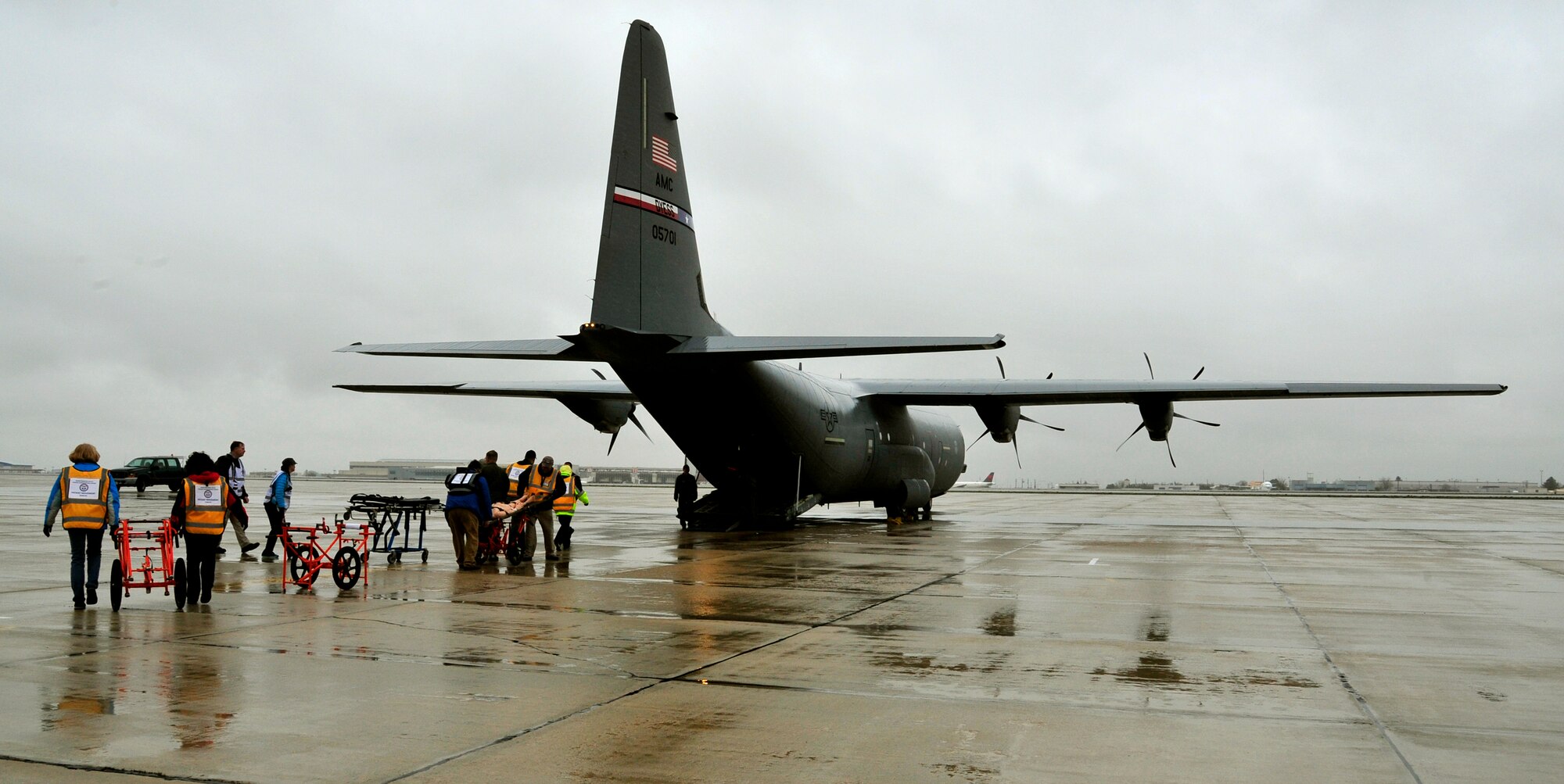 Civilian litter carry volunteers carry simulated patients to an aircraft during a national disaster exercise, Ultimate Caduceus 2014, at Boise, Idaho, April 1, 2014. Both technicians are assigned to the 375th Aeromedical Evacuation Squadron, Scott AFB, Il. During Ultimate Caduceus, part of the Federal Emergency Management Agency’s National Capstone Exercise, AE members provided medical support, processed and transferred patients. Utlimate Caduceus 14 illustrates the critical partnership between Mobility Air Forces and the interagency, in this case FEMA, by exercising disaster relief operations. 
The aeromedical teams were comprised of more than 18 AE crew members from Pope Army Airfield, N.C., Scott AFB, Ill., and Cheyenne ANG base, Wyo.  (U.S. Air Force photo/ Staff Sgt. Stephenie Wade)
