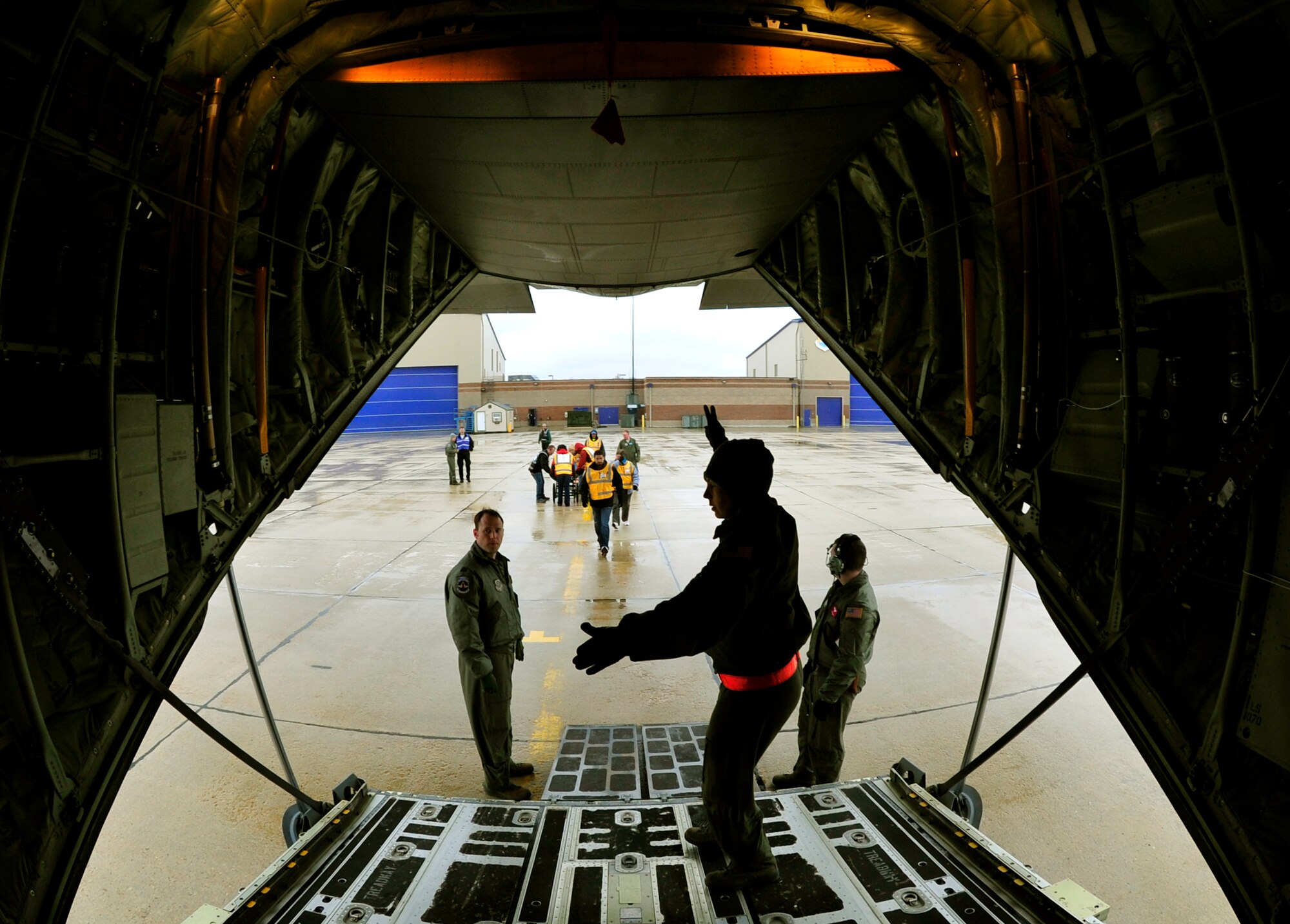 Capt. Tracy Minke, 187th Aeromedical Evacuation Squadron flight nurse, instructs two litter carry volunteers when to approach the aircraft to pick up patients during a national disaster exercise, Ultimate Caduceus 2014, at Boise, Idaho, April 1, 2014. Both technicians are assigned to the 375th Aeromedical Evacuation Squadron, Scott AFB, Il. During Ultimate Caduceus, part of the Federal Emergency Management Agency’s National Capstone Exercise, AE members provided medical support, processed and transferred patients. Utlimate Caduceus 14 illustrates the critical partnership between Mobility Air Forces and the interagency, in this case FEMA, by exercising disaster relief operations. The aeromedical teams were comprised of more than 18 AE crew members from Pope Army Airfield, N.C., Scott AFB, Ill., and Cheyenne ANG base, Wyo.(U.S. Air Force photo/ Staff Sgt. Stephenie Wade)