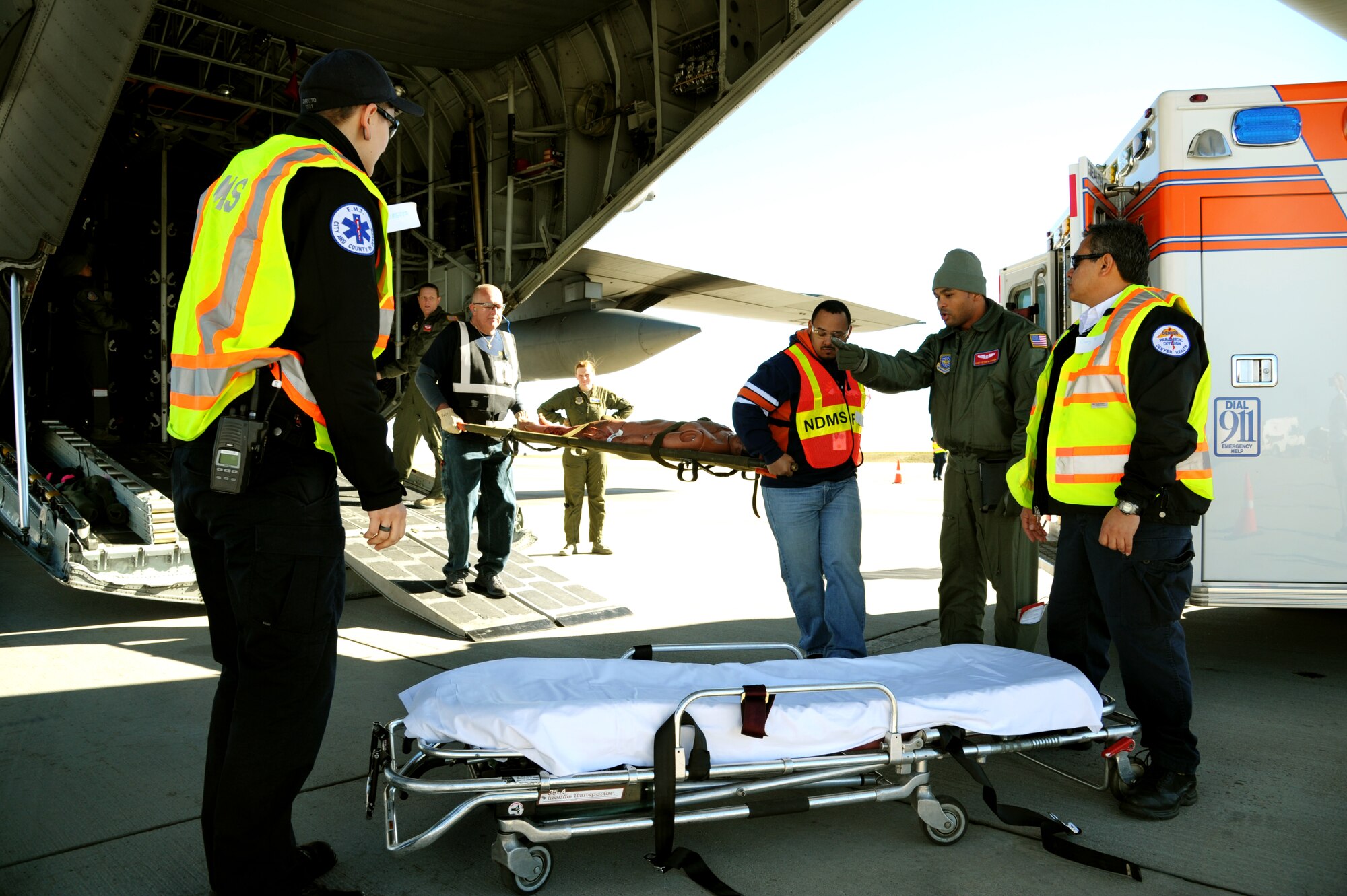 Tech. Sgt. Rosaura Newton, 375th Aeromedical Evacuation Squadron technician, informs litter carry volunteers of unloading instructions during a national disaster exercise, Ultimate Caduceus 2014, at Cheyenne Air National Guard Base, Wyo., March 31, 2014. During Ultimate Caduceus, part of the Federal Emergency Management Agency’s National Capstone Exercise, AE members provided medical support, processed and transferred patients. The aeromedical teams were comprised of more than 18 AE crew members from Pope Army Airfield, N.C., Scott AFB, Ill., and Cheyenne ANG base, Wyo. (U.S. Air Force photo/ Staff Sgt. Stephenie Wade)