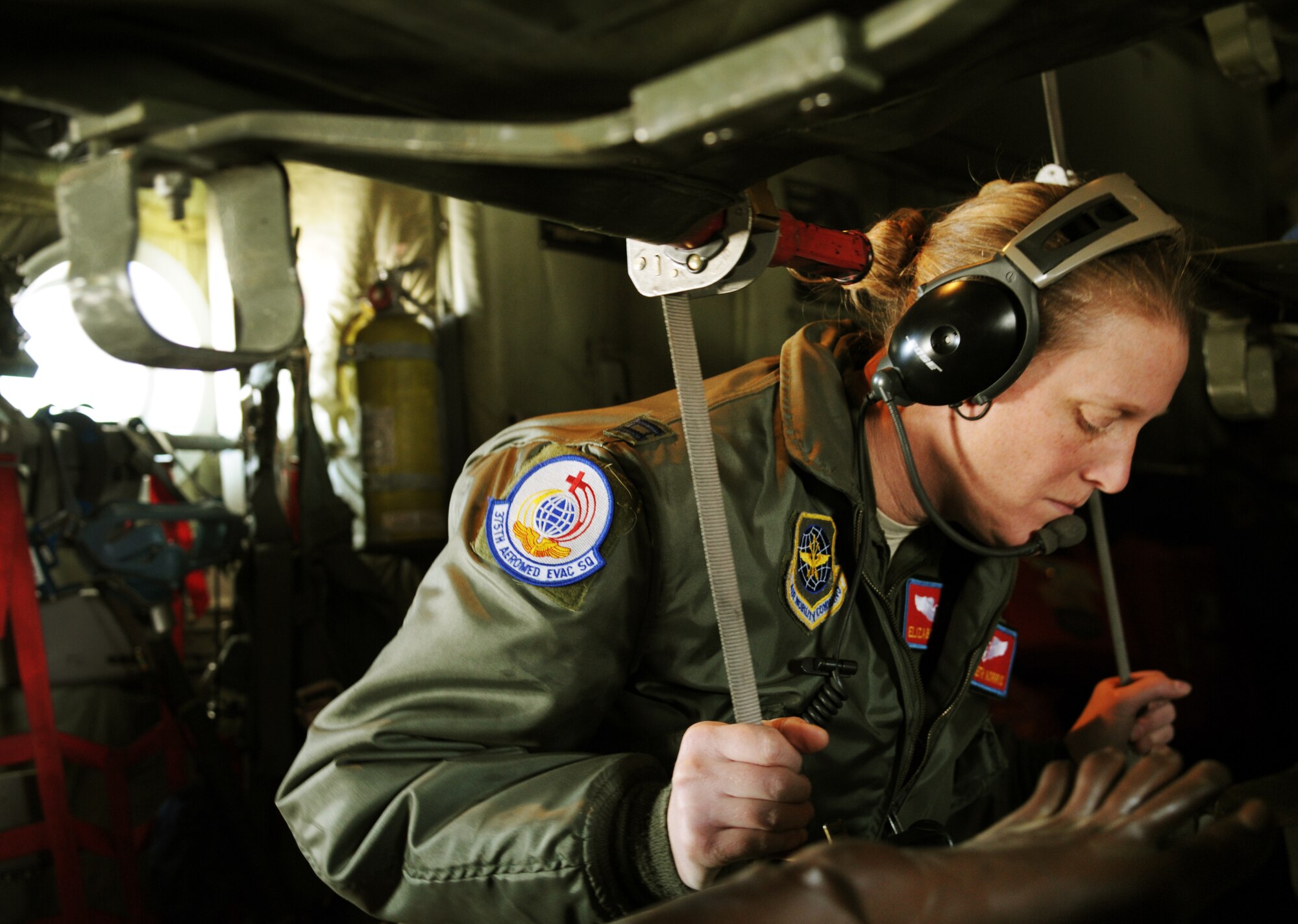 Capt. Elizabeth Norris, 375th Aeromedical Evacuation Squadron flight nurse, checks the feet of a simulated diabetic patient in the air during a national disaster exercise, Ultimate Caduceus 2014, at Cheyenne Air National Guard Base, Wyo., March 31, 2014. Both technicians are assigned to the 375th Aeromedical Evacuation Squadron, Scott AFB, Il. During Ultimate Caduceus, part of the Federal Emergency Management Agency’s National Capstone Exercise, AE members provided medical support, processed and transferred patients. The aeromedical teams were comprised of more than 18 AE crew members from Pope Army Airfield, N.C., Scott AFB, Ill., and Cheyenne ANG base, Wyo. (U.S. Air Force photo/ Staff Sgt. Stephenie Wade)