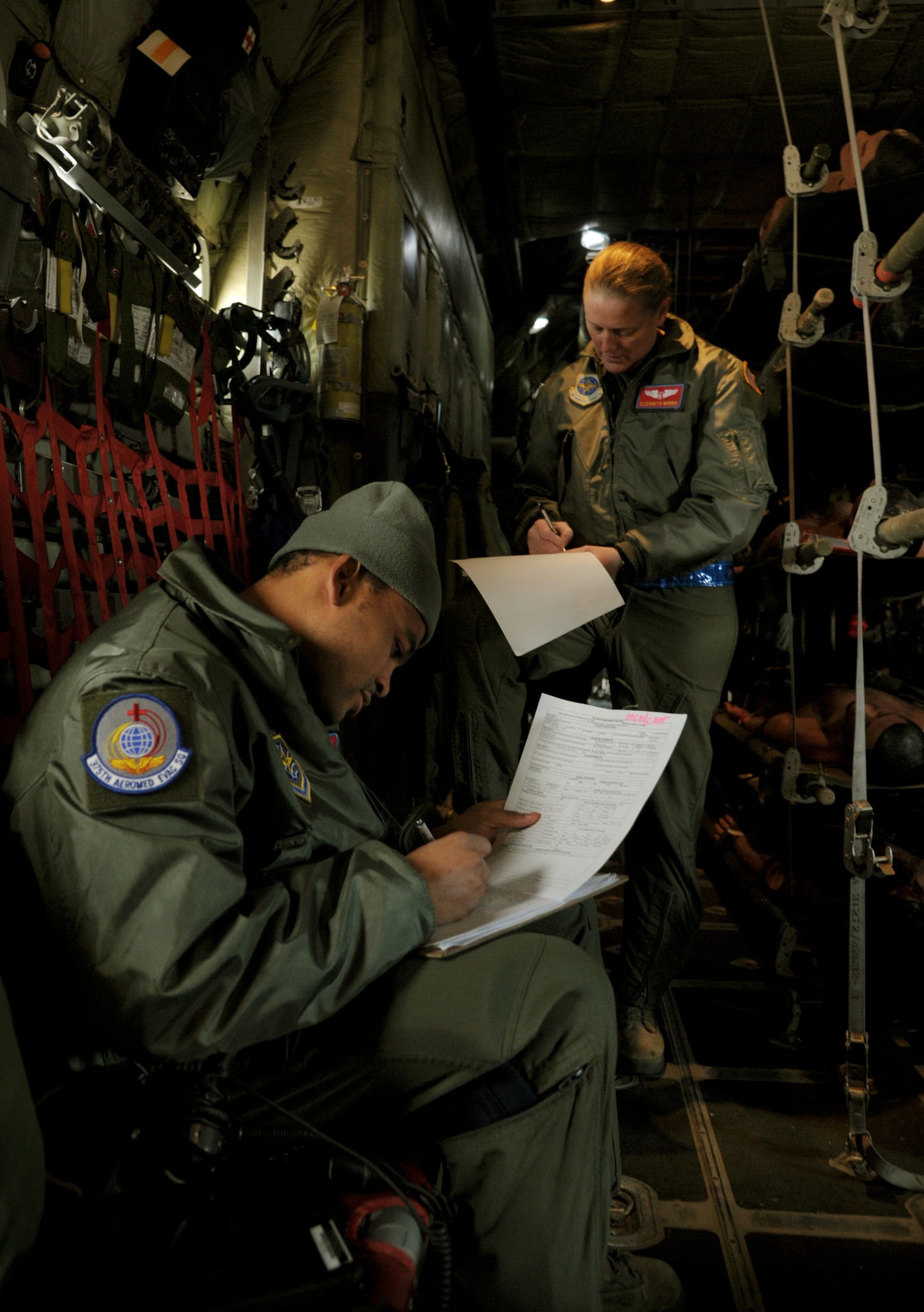 Capt. Elizabeth Norris, flight nurse and Staff Sgt. Sean McCurbin, aeromedical technician, document simulated patient treatment in the air during a national disaster exercise, Ultimate Caduceus 2014, at Cheyenne Air National Guard Base, Wyo., March 31, 2014. During Ultimate Caduceus, part of the Federal Emergency Management Agency’s National Capstone Exercise, AE members provided medical support, processed and transferred patients. The aeromedical teams were comprised of more than 18 AE crew members from Pope Army Airfield, N.C., Scott AFB, Ill., and Cheyenne ANG base, Wyo. (U.S. Air Force photo/ Staff Sgt. Stephenie Wade)