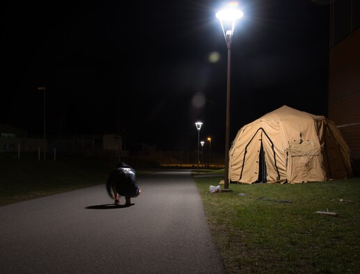 An Airman ties his shoes before participating in a memorial run March 27, 2014, at Grafenwoehr, Germany. Not a moment went by where there wasn’t at least one TACP Airman on the track, some ended up running for 12 hours before they finished. (U.S. Air Force photo/Senior Airman Jonathan Stefanko)