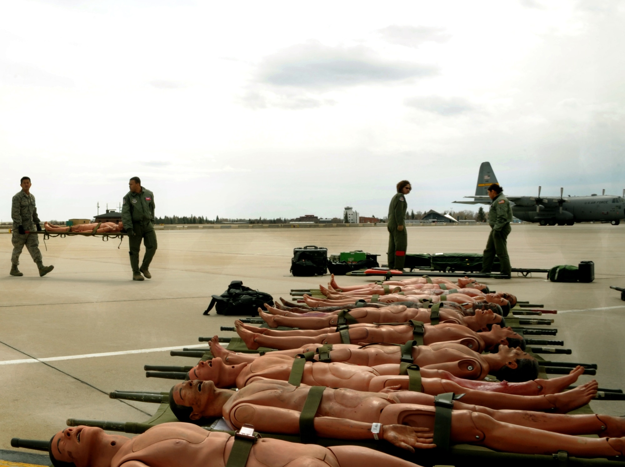 Aeromedical Evacuation members load simulated litter patients onto a C-130 during a national disaster exercise, Ultimate Caduceus 2014, at Cheyenne Air National Guard Base, Wyo., March 30, 2014. During Ultimate Caduceus, part of the Federal Emergency Management Agency’s National Capstone Exercise, AE members provided medical support processed and transferred patients. The aeromedical teams were comprised of more than 18 AE crew members from Pope Army Airfield, N.C., Scott AFB, Il., and Cheyenne ANG base, Wyo. (U.S. Air Force photo/ Staff Sgt. Stephenie Wade)