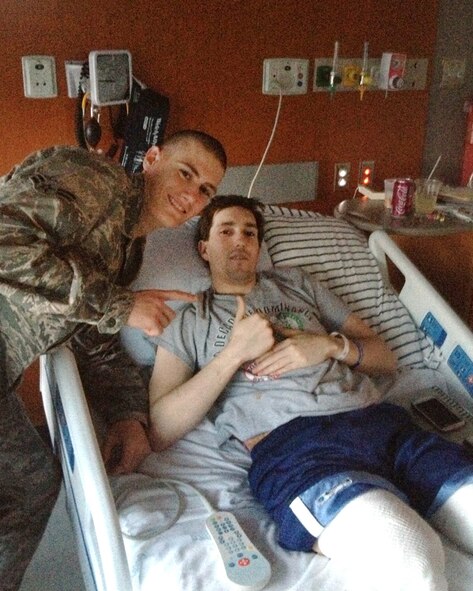 BOSTON -- Airman 1st Class Alan Bauman (left) visited his bother Jeff Bauman (right) in a Boston hospital upon returning from Basic Military Training in April of 2013. Alan was in BMT during the Boston Marathon bombing, where Jeff lost both his legs from an explosion near the finish line. (Courtesy Photo/RELEASED)