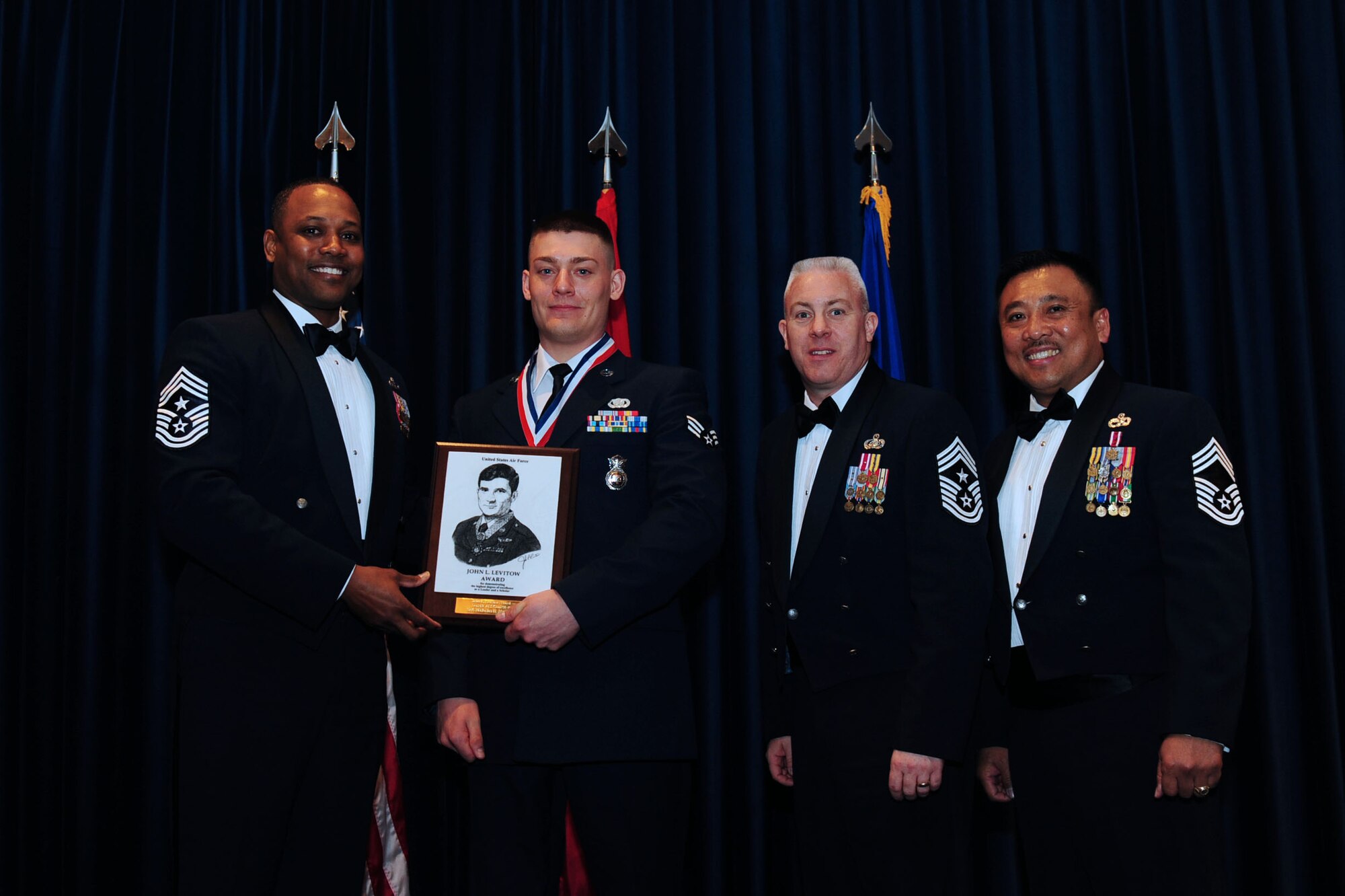 Senior Airmen Nicholas Murphy, 39th Security Forces Squadron, receives the John L. Levitow Award from Col. Craig Wills, 39th Air Base Wing commander, during the Airmen Leadership School graduation April 3, 2014, Incirlik Air Base, Turkey. The Levitow Award is the highest achievement for enlisted Airmen enrolled in U.S. Air Force professional military education. There are four levels of PME: ALS, NCO Academy, Air Force Senior NCO Academy and Chief Master Sergeant Leadership Course. (U.S. Air Force photo by Senior Airman Nicole Sikorski/Released)