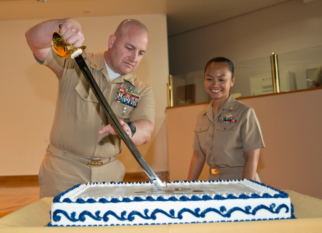 Master Chief Petty Officer Eric S. Anderson, left, and Chief Petty Officer Sandra M. Go-Lubiano cut a cake April 1 on Camp Hansen during a celebration of the 121st Chief Petty Officer Birthday. The cake cutting is a time-honored ceremony in which the oldest service member present passes the first piece to the junior service member, representing the passing and sharing of experience between generations. Anderson was the oldest the chief petty officer present and command master chief petty officer of III Marine Expeditionary Force. Go-Lubiano was the youngest chief petty officer present and a corpsman with 3rd Battalion, 12th Marine Regiment, 3rd Marine Division, III MEF.