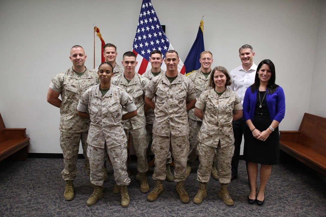 Staff members with the Camp Foster Legal Assistance Office pose for a photo April 7 in a courtroom of the Legal Services Support Section Building on Camp Foster. The American Bar Association recently selected the office, and Capt. Nicholas W. Mull, far left, for the Legal Assistance to Military Personnel Distinguished Service Awards for their efforts throughout 2013. “Our office supports operational readiness of service members and units by ensuring private civil legal issues do not interfere with the military mission,” said Mull, a judge advocate with Legal Services Support Section Pacific, Marine Corps Installations Pacific. 