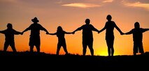 Silhouette sunset family joining hands        