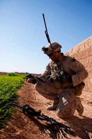 Cpl. Charles Kristel, a Schenectady, N.Y., native and team leader with 1st Battalion, 9th Marine Regiment, Regional Command (Southwest), radios another section of Marines during an interdiction operation in Helmand province, Afghanistan, Dec. 19, 2013. Kristel, an anti-tank missileman by trade, lead a section of infantry Marines during the clearing operation.(Photo By: Cpl. Paul Peterson)