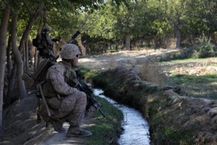 U.S. Marine Corps Staff Sgt. Alberto Boy, a platoon sergeant with India Company, 3rd Battalion, 7th Marine Regiment, kneels during a security patrol near Forward Operating Base Musa Qala, Helmand province, Afghanistan, Oct. 19, 2013. The Marines of 3/7 patrolled to reduce enemy activity in the area. (Official Marine Corps photo by Lance Cpl. James Mast / Released)