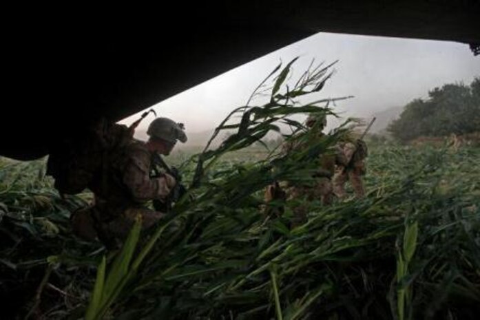 U.S. Marines with Golf Company, 2nd Battalion, 8th Marines, Regimental Combat Team 7 and Afghan National Security Forces, run out of a CH-53E Super Stallion aircraft, assigned to Marine Heavy Helicopter Squadron 461 (HMH-461), in the Helmand province, Afghanistan, Aug. 20, 2013. HMH-461 provided aerial support for Marines with Golf Company, 2nd Battalion, 8th Marines, Regimental Combat Team 7 and Afghan National Security Forces during an International Security Assistance Force and North Atlantic Treaty Organization operation. (U.S. Marine Corps photo by Sgt. Gabriela Garcia/Released)