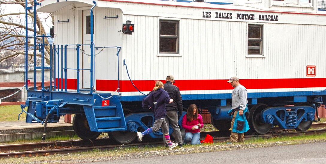 The Dalles Lock and Dam Visitor Center hosted its first-ever geocaching event Sat., March 29, 2014.

The Amazing Race, Geocache Style drew more than 50 people of all ages and skill levels, who each braved the erratic weather to participate in this outdoor treasure hunt.

For many participants, it was their first experience with geocaching, but park rangers and volunteers assisted them with using a GPS to guide them to the hidden treasures.

 Five geocaches were placed specifically for this event at Seufert and Patterson parks and the connecting Riverfront Trail. Each geocache was stuffed with items promoting water safety, reminding everyone to play it safe and always wear a life jacket!

Upon completion of the race, all participants received a certificate of completion, signed by a park ranger.  

When a family of smiling faces returned to the visitor center, they were asked if they would go geocaching again. “Yes! We are hooked now,” said participant Jenni Nuzzi.

“It is great to see people bringing their friends and family outdoors to use technology and enjoy the day," said Emma Nelson, a Park Ranger at The Dalles Lock and Dam. "Despite the moody weather, everyone left with goodies in their bags and smiles on their faces.” 
