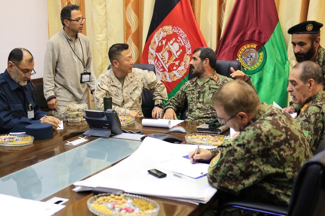 Afghan National Army (ANA) Soldier Maj. Gen. Sayed Malouk, center right, commander of Afghanistan's 215th Corps, talks to U.S. Marine Corps Brig. Gen. Daniel D. Yoo, center left, commander of Regional Command (Southwest) (RC(SW)), about current security operations during the Afghan presidential elections from inside the Operational Coordination Center- Regional (OCC-R) aboard Camp Shorabak, Helmand province, Afghanistan, April 5, 2014. The 1393 (2014) presidential elections is the first year Afghan National Security Forces (ANSF) have taken the lead for such an event.
(Official U.S. Marine Corps photo by Lance Cpl. Darien J. Bjorndal, Marine Expeditionary Brigade Afghanistan/ Not Released) (Portions of this image have been obscured to maintain operational security.)