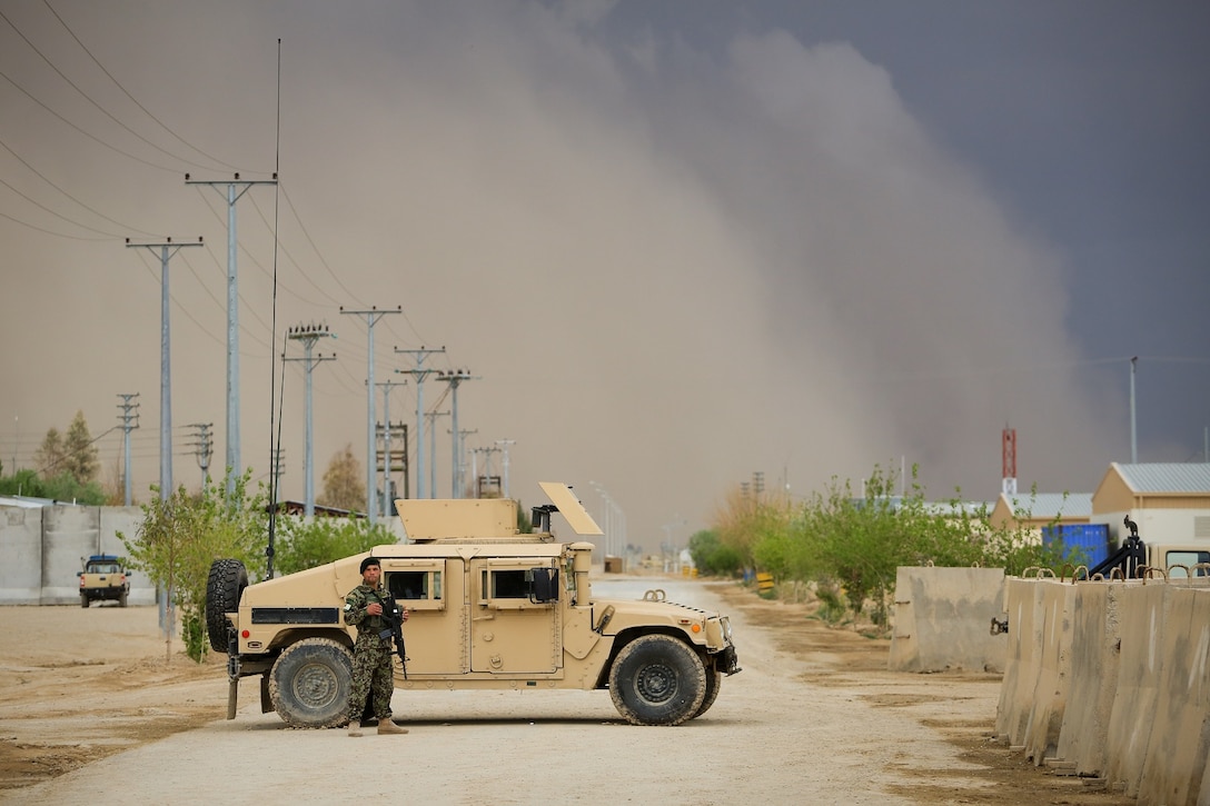 A Afghan National Army (ANA) soldier, assigned to the 215th Corps, stands next to an ANA Humvee while guarding the Operational Coordination Center- Regional (OCC-R) during the Afghan presidential elections, as a sandstorm approaches, aboard Camp Shorabak, Helmand province, Afghanistan, April 5, 2014. The 1393 (2014) presidential elections is the first year Afghan National Security Forces (ANSF) have taken the lead for such an event.
(Official U.S. Marine Corps photo by Lance Cpl. Darien J. Bjorndal, Marine Expeditionary Brigade Afghanistan/ Not Released)