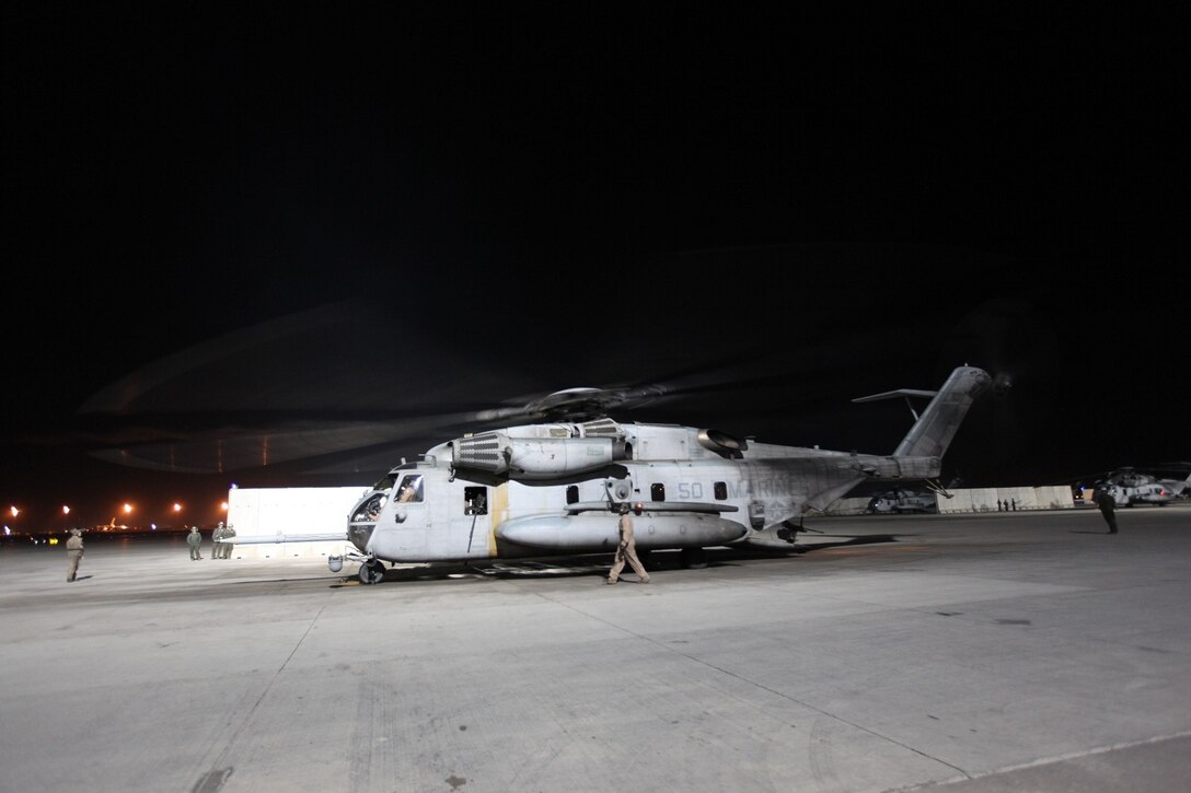 A CH-53E Super Stallion and its crew with Marine Heavy Helicopter Squadron 466, prepares for a training mission with the Marines of the Georgian Liaison Team and a platoon from the 31st Georgian Light Infantry Battalion, April 2, 2014. The Super Stallions inserted the Georgian soldiers and Marines of the GLT at the training site as the sun sat just above the horizon, leaving behind a swirling cloud of dirt and rocks as they took off. For the platoon of Georgian soldiers, this was their first time conducting a training mission with a helicopter. (USMC Photo By: Sgt. Frances Johnson/Released)
