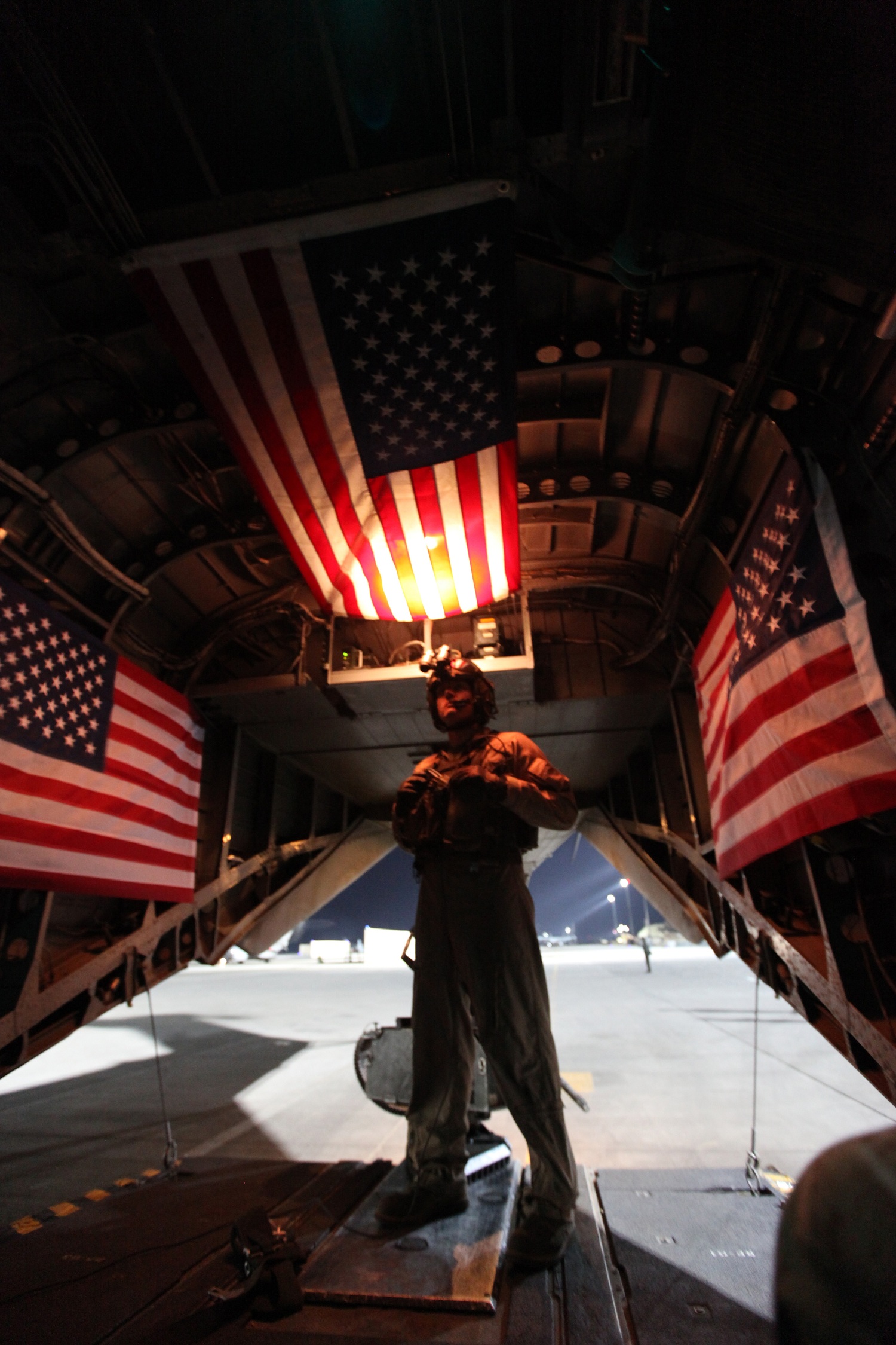 Staff Sgt. Michael Walk, a crew chief with Marine Heavy Helicopter Squadron 466, stands on the ramp of a CH-53E Super Stallion as it prepares for a training mission with the Marines of the Georgian Liaison Team and a platoon from the 31st Georgian Light Infantry Battalion, April 2, 2014. The Super Stallions inserted the Georgian soldiers and Marines of the GLT at the training site as the sun sat just above the horizon, leaving behind a swirling cloud of dirt and rocks as they took off. For the platoon of Georgian soldiers, this was their first time conducting a training mission with a helicopter. (USMC Photo By: Sgt. Frances Johnson/Released)