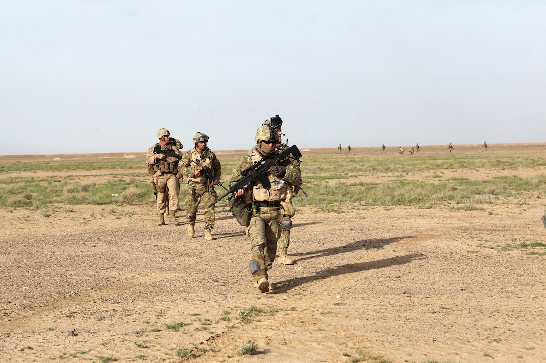 Georgian soldiers from the 31st Georgian Light Infantry Battalion and Marines with the Georgian Liaison Team patrol an area during a training exercise in Helmand province, Afghanistan, April 2, 2014. The training exercise consisted of the soldiers and GLT members patrolling an area to sweep and clear any improvised explosive devices and securing two simulated objectives. After the training was complete, they set a perimeter for a helicopter landing zone in order to be picked up by two CH-53E Super Stallions. (USMC Photo By: Sgt. Frances Johnson/Released)