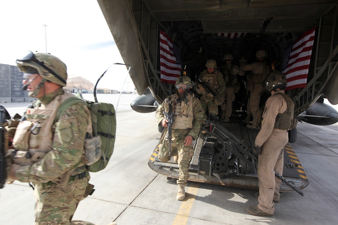 Georgian soldiers with the 31st Light Infantry Battalion off-load from a CH-53E Super Stallion following a training exercise in Helmand province, Afghanistan, April 2, 2014. The Super Stallions inserted the Georgian soldiers and Marines of the Georgian Liaison Team at the training site as the sun sat just above the horizon, leaving behind a swirling cloud of dirt and rocks as they took off. For the platoon of Georgian soldiers, this was their first time conducting a training mission with a helicopter. (USMC Photo By: Sgt. Frances Johnson/Released)