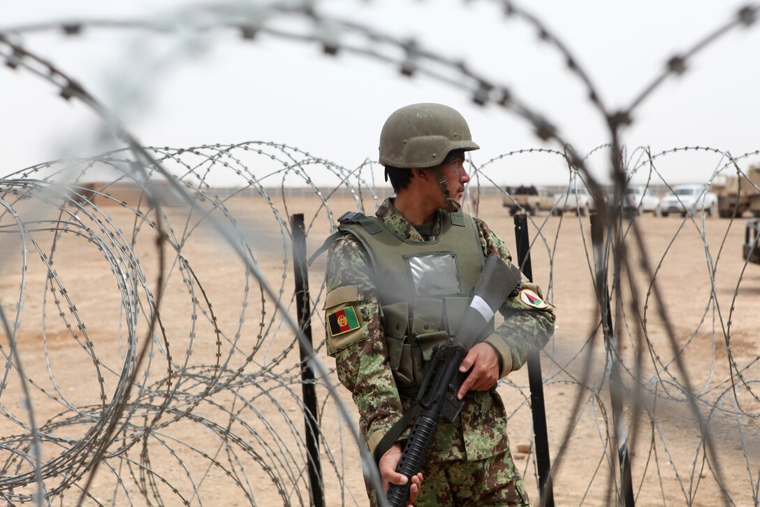 A soldier with 4th Tolay, 6th Kandak, 4th Brigade, Afghan National Army, provides security during a final training exercise for the security training program with Regional Corps Battle School aboard Camp Bastion, Afghanistan, April 1, 2014.




