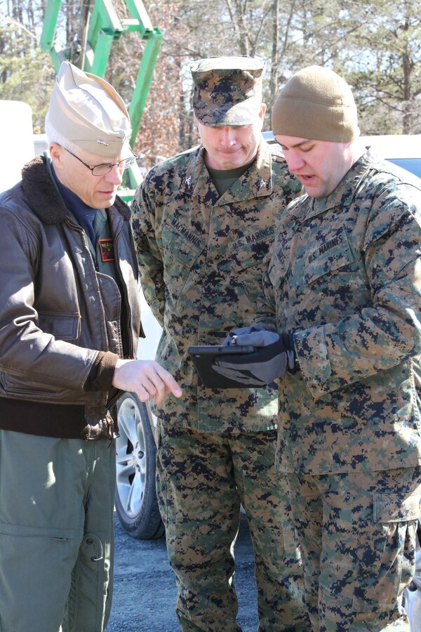 Lance Cpl. Cody Barss explains how he landed a helicopter utilizing an Autonomous Aerial Cargo/Utility System prototype to Rear Adm. Matt Klunder, chief of naval research, left, and Col. Andrew MacMannis, deputy director for the Marine Corps Warfighting Laboratory, during a demonstration at Marine Corps Base Quantico on Feb. 27, 2014. According to the Office of Naval Research, the system is designed to enable autonomous approaches and landings at unprepared landing sites, minimally supervised by field operators with no special training, for manned or unmanned rotary-wing aircraft