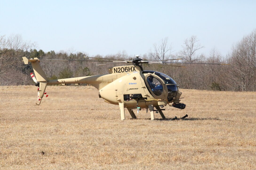 A helicopter sits in the field at Range 15 after landing during a demonstration of the Autonomous Aerial Cargo/Utility System at Marine Corps Base Quantico on Feb. 27, 2014. AACUS is designed to work with manned or unmanned rotary-wing aircraft and could be used with the entire Marine Corps rotary-wing fleet.  
