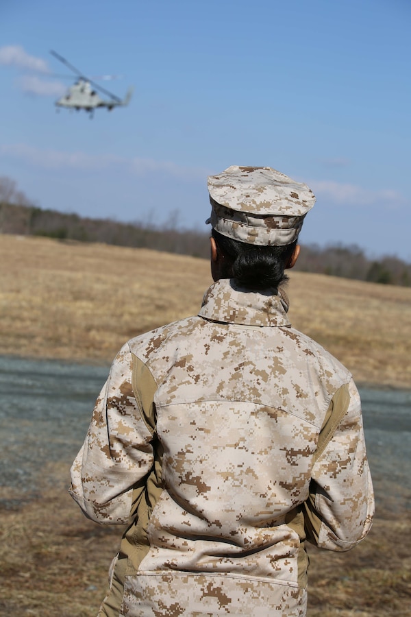 Sgt. Jessica Wright, a field wireman currently assigned as an augment to Security Battalion, MCB Quantico, uses a tablet to control a helicopter during an Autonomous Aerial Cargo/Utility System prototype demonstration at Marine Corps Base Quantico on March 20, 2014. The system is designed to be simple so it can be used by individuals with no flight experience, with the goal of being used for logistical runs and, possibly in the long-term, casualty evacuations.