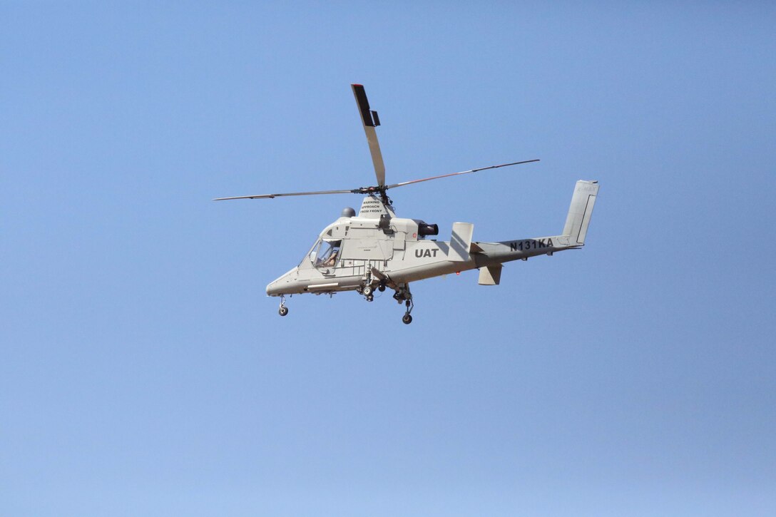 A helicopter descends to a landing site during an Autonomous Aerial Cargo/Utility System prototype demonstration at Marine Corps Base Quantico on March 20, 2014. AACUS is a system of software and sensors which provides autonomous approach and landing capabilities to any rotary aircraft, manned or unmanned. 
