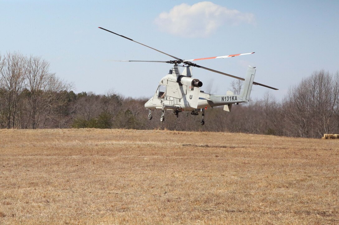 A helicopter attempts to land during an Autonomous Aerial Cargo/Utility System prototype demonstration at Marine Corps Base Quantico on March 20, 2014. AACUS is a system of software and sensors which provides autonomous approach and landing capabilities to any rotary aircraft, manned or unmanned. 