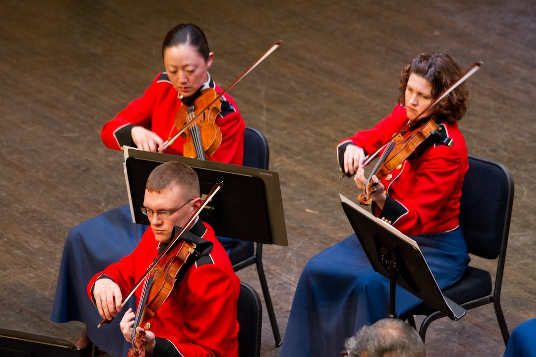 On April 6, 2014, at Rachel M. Schlesinger Concert Hall and Arts Center, the Marine Chamber Orchestra performed Rodion Shchedrin’s Carmen Suite and Igor Stravinsky’s Suite from Pulcinella. Pictured, Staff Sgts. Christopher Franke, Chaerim Smith, and Karen Johnson. (U.S. Marine Corps photo by Gunnery Sgt. Amanda Simmons/released