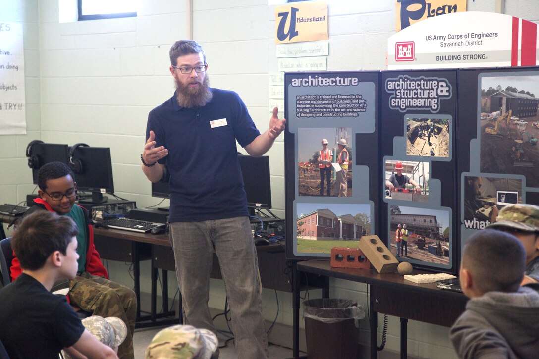 FORT STEWART, Ga. – Craig Walters, a civil engineer with the U.S. Army Corps of Engineers Savannah District, Fort Stewart Resident Office, talks to students at Diamond Elementary School about engineering careers with the Corps during a school-wide "STEMposium" April 4, 2014. The event focused on getting children interested in Science, Technology, Engineering and Math (STEM) career fields. 