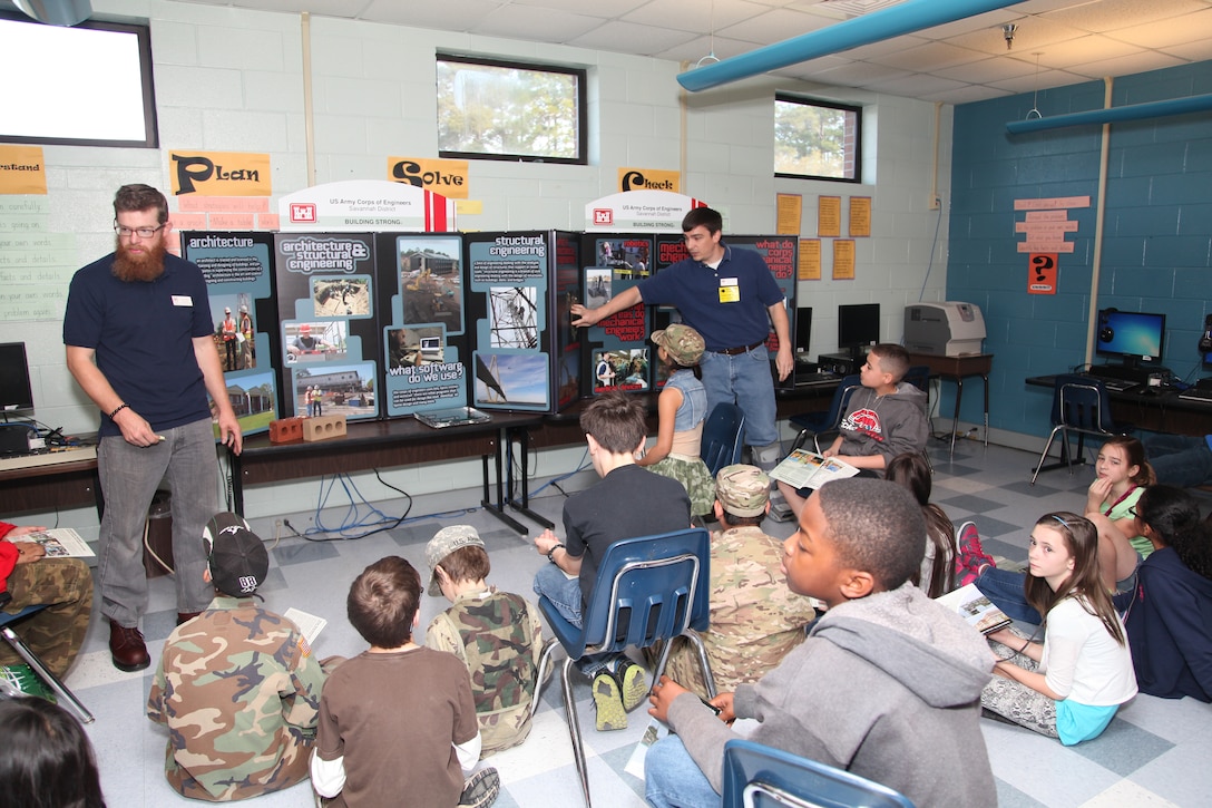 FORT STEWART, Ga. – Civil Engineer Craig Walters (left) and Mechanical Engineer Matt Kilmer with the U.S. Army Corps of Engineers Savannah District, Fort Stewart Resident Office, talk to students at Diamond Elementary School about engineering careers with the Corps during a school-wide "STEMposium" April 4, 2014. The event focused on getting children interested in Science, Technology, Engineering and Math (STEM) career fields.