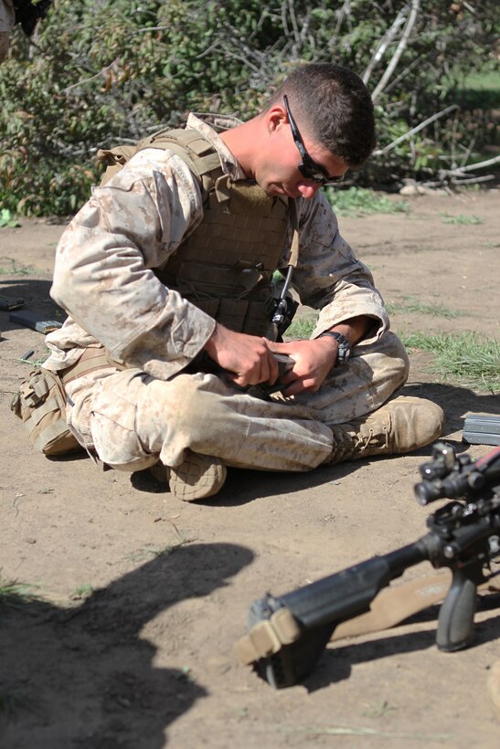 Corporal Andres Isidro, assault man, Fox Company, 2nd Battalion, 4th Marine Regiment, reloads magazines during a squad and fire team maneuver exercise aboard Marine Corps Base Camp Pendleton, Calif., April 2, 2014. The exercise allowed Marines from the company to re-familiarize themselves with their weapon systems as well as 60 mm mortars, M240 B machine guns, Light Anti-tank Weapon (LAW) and while practicing squad and fire team tactics.

