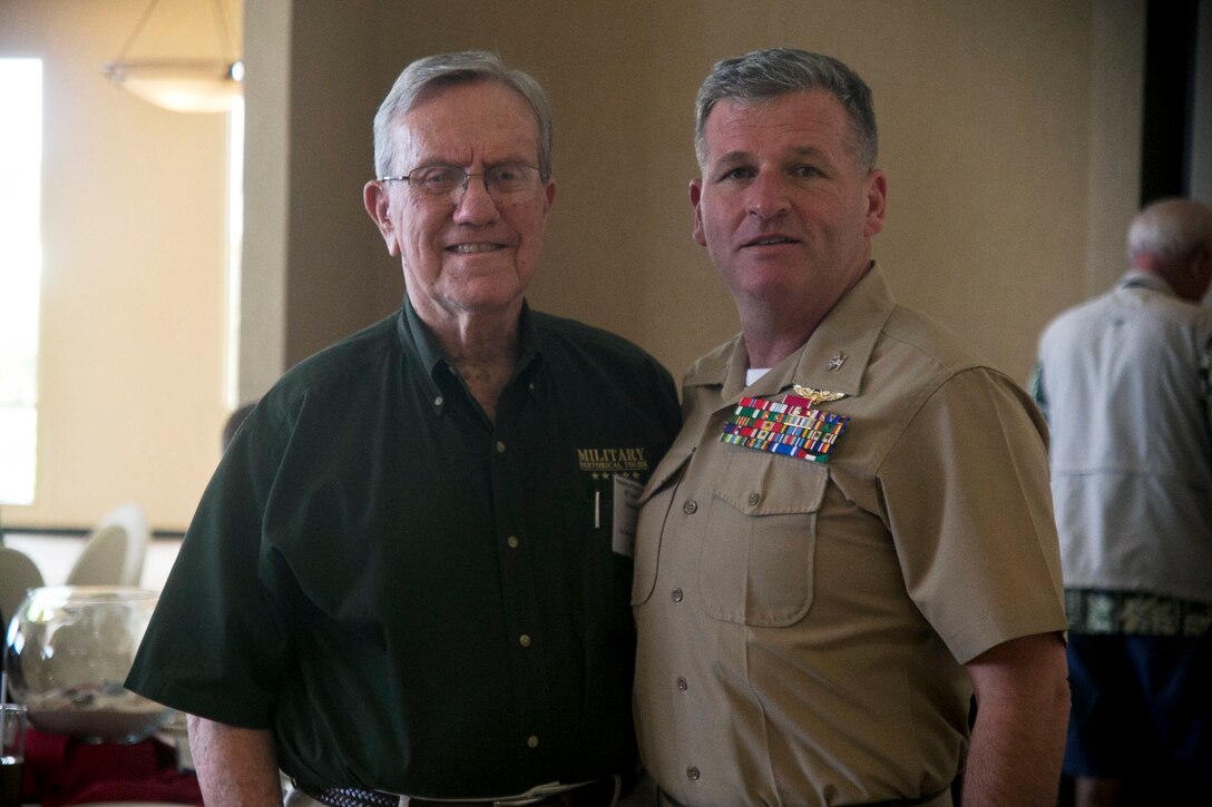 Colonel Philip Zimmerman, Marine Corps Activity Guam Officer in Charge, stands with retired Colonel Warren Wiedham at a gathering of veterans during the Iwo Jima Association of America before a military historical tour. The Iwo Jima Association of America hosts veterans and members to the Pacific islands including Iwo Jima in part of a historical tour.