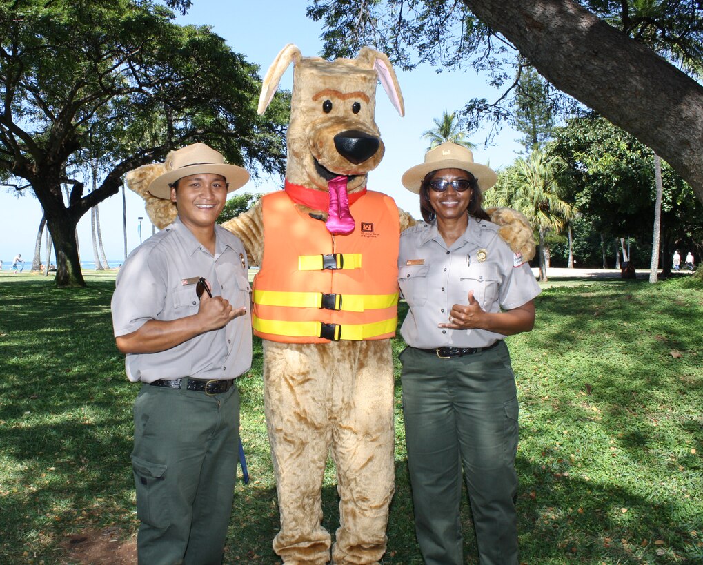 HONOLULU (April 5, 2014) - U.S. Army Corps of Engineers Park Rangers Don Espaniola and Angela Jones say Aloha to Bobber the Water Safety Dog after attending a beach and berm clean up as part of Earth Month 2014 at the Corps' Pacific Regional Visitor Center at Fort DeRussy.  