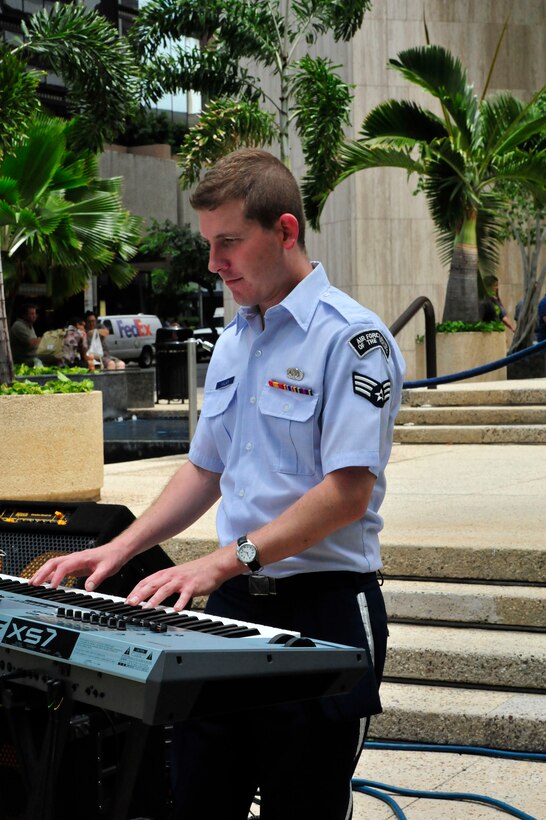 HONOLULU, Hawaii –  SrA Adam Walker, pianist with the USAF Band of the Pacific-Hawaii, solos during the jazz standard "Taking a Chance on Love". Papana, the jazz ensemble with the USAF Band of the Pacific-Hawaii, played at Bishop Square, Apr. 3, 2014. The Band of the Pacific-Hawaii plays over 100 annual public concerts, in efforts to build stronger community and military ties. (US Air Force Photo/SSgt Courtney Clifford/released)