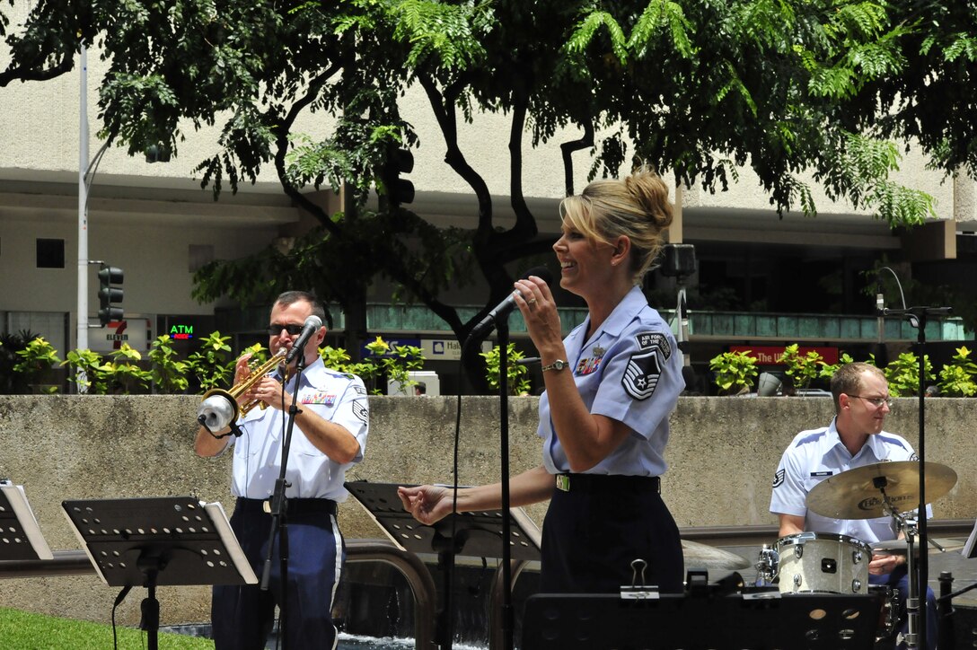 HONOLULU, Hawaii –  MSgt Lara Murdzia, vocalist with the USAF Band of the Pacific-Hawaii, sings a few jazz standards for the lovely people of downtown Honolulu. Papana, the jazz ensemble with the USAF Band of the Pacific-Hawaii, played at Bishop Square, Apr. 3, 2014. The Band of the Pacific-Hawaii plays over 100 annual public concerts, in efforts to build stronger community and military ties. (US Air Force Photo/SSgt Courtney Clifford/released)