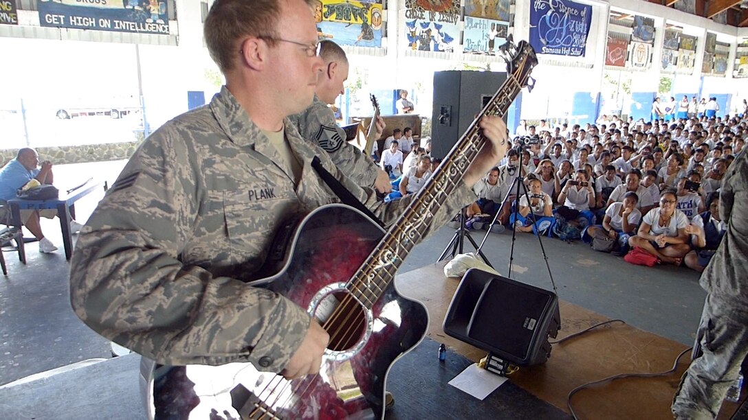 UTULEI BEACH, American Samoa-- Bassist SrA Brian Plank performing with Small Kine for over 500 students at Samoana High School on March 26, 2014. (US Air Force Photo/Michael Smith/ Released)