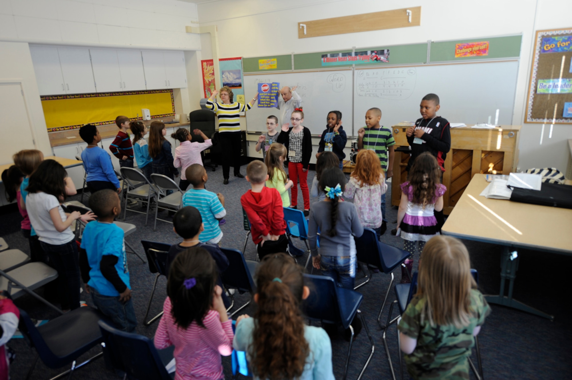 Volunteer teachers and students participate in an after-school Good News Club meeting at Ursa Major Elementary School on Joint Base Elmendorf-Richardson, Alaska, March 21, 2014. The GNC program is a ministry of Child Evangelism Fellowship, a worldwide organization in which trained teachers meet with groups of children in schools, homes, community centers, churches, apartment complexes or other locations the children can easily and safely meet with their parents??? permission. (U.S. Air Force photo/Staff Sgt. Robert Barnett)