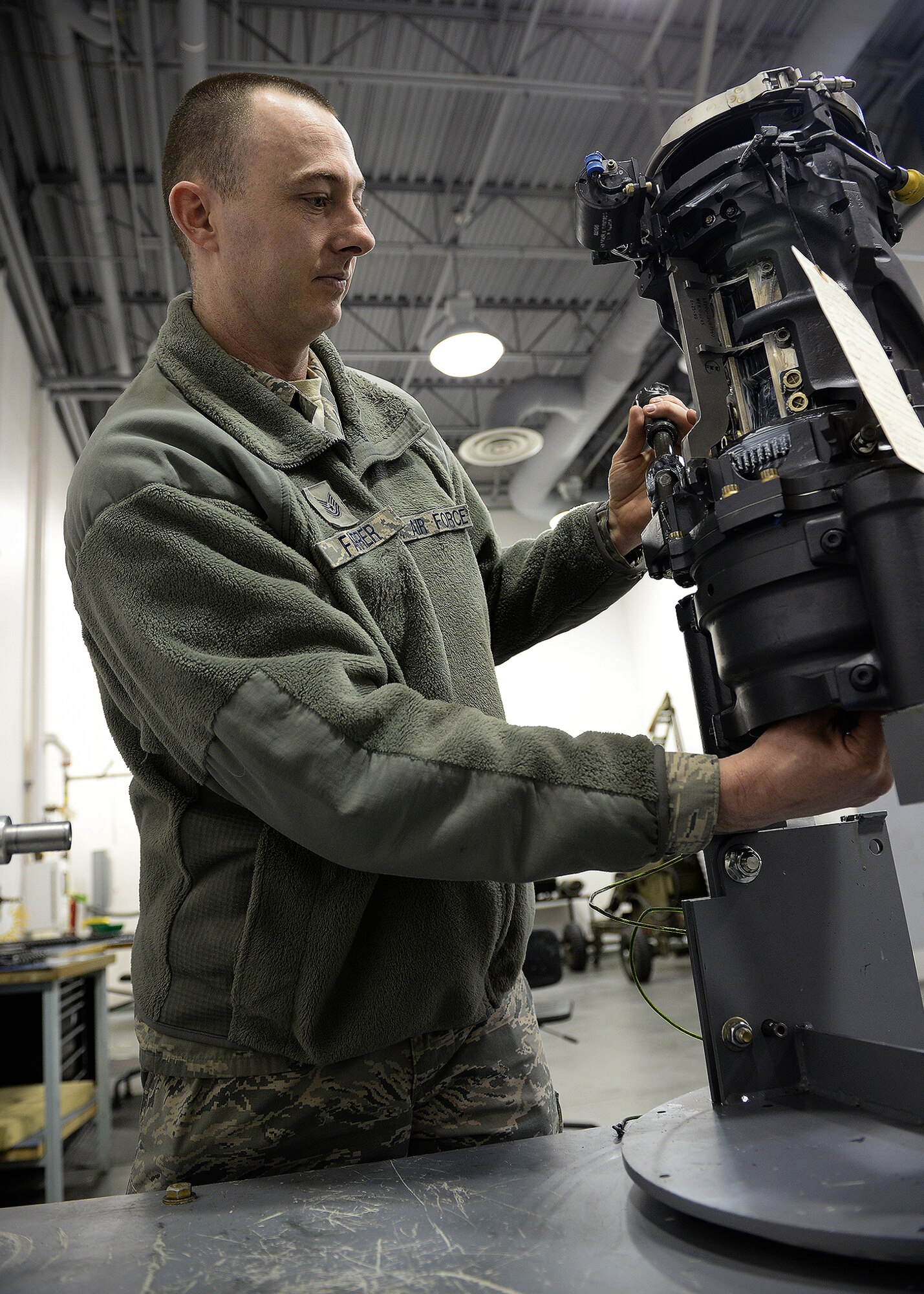 Tech. Sgt. Steven Farrer, 354th Maintenance Group weapons quality assurance inspector, checks sprockets on an M-61 A1 20mm Vulcan weapons system April 7, 2014, Eielson Air Force Base, Alaska. QA inspectors ensure maintainers are following technical orders and ensure pilot safety and the correct use of tax dollars. (U.S. Air Force photo by Staff Sgt. Shawn Nickel/Released)