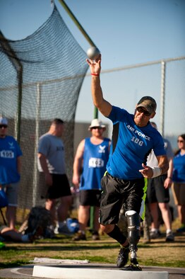 Master Sgt. Christopher Aguilera, 66th Rescue Squadron first sergeant, attempts a shot put throw April 8 at Rancho High School in Las Vegas. Aguilera is competing for one of 40 positions to represent the Air Force team during the Wounded Warrior games later this year. Aguilera is a survivor of the Pedro 66,  HH-60 Pave Hawk helicopter crash in Afghanistan June 2010 killing five of his fellow crew members.  (U.S. Air Force photo by Airman 1st Class Thomas Spangler)