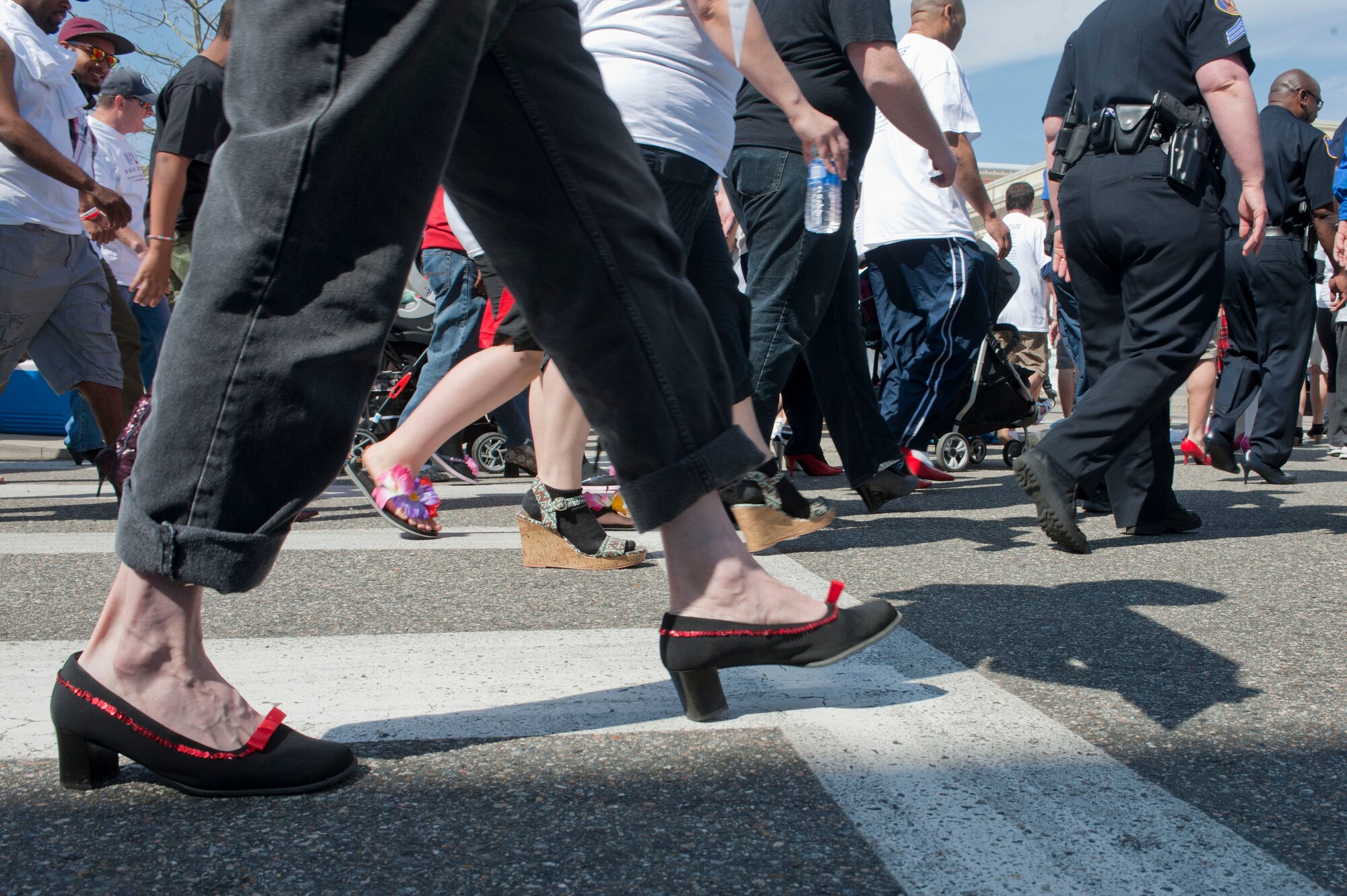 Participants walk in high heels during a Sexual Assault Awareness Month event in Hampton, Va., April 5, 2014. Men wore heels during Walk a Mile in Her Shoes as a symbol of what women go through in everyday life, to include women who are victims of a sexual crime. (U.S. Air Force photo by Staff Sgt. Stephanie Plichta/Released) 