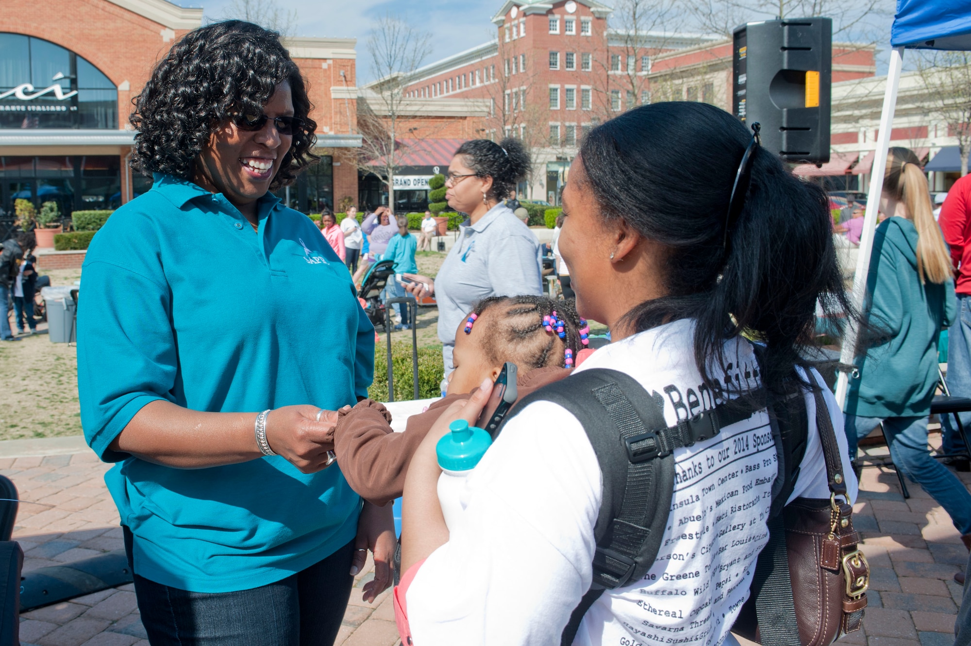 (Right) Bernadette Hardy, 633rd Air Base Wing sexual assault response coordinator, speaks with Candice Thompson, 633rd Aerospace Medical Squadron pathologist technician, during Walk a Mile in Her Shoes in Hampton, Va., April 5, 2014. Thompson is a victim advocate and works closely with Hardy to ensure victims of sexual assault receive necessary care to recover. (U.S. Air Force photo by Staff Sgt. Stephanie Plichta/Released) 