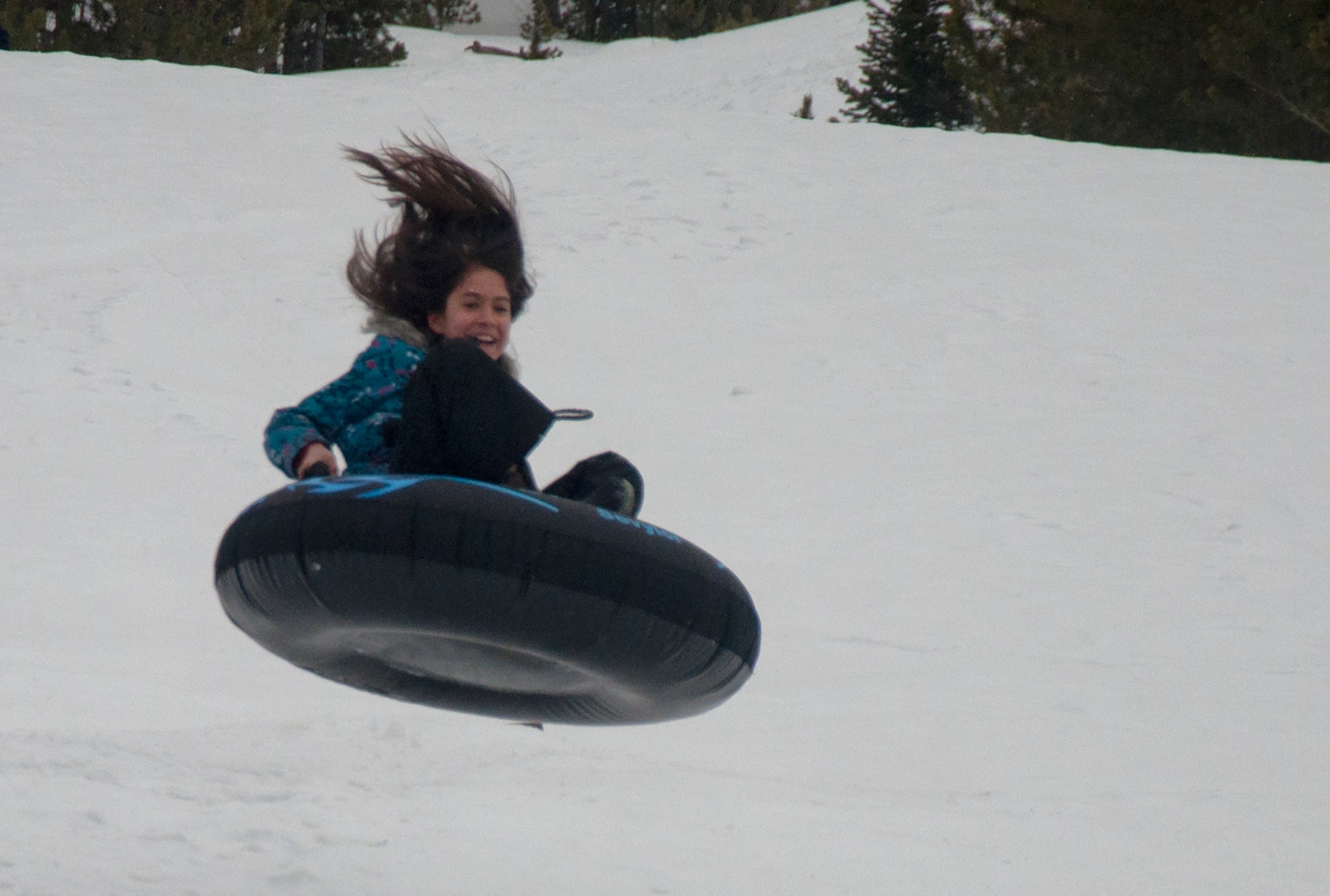 140403-F-GZ967-111 Abi Taylor, 10, takes flight April 3 as she tubes down a hill in Vedauwoo. Taylor, along with a group of 13 other children, participated in Outdoor Recreation’s BRAT camp, where they explored the local area and experienced various outdoor activities. (U.S. Air Force photo by Airman 1st Class Brandon Valle)