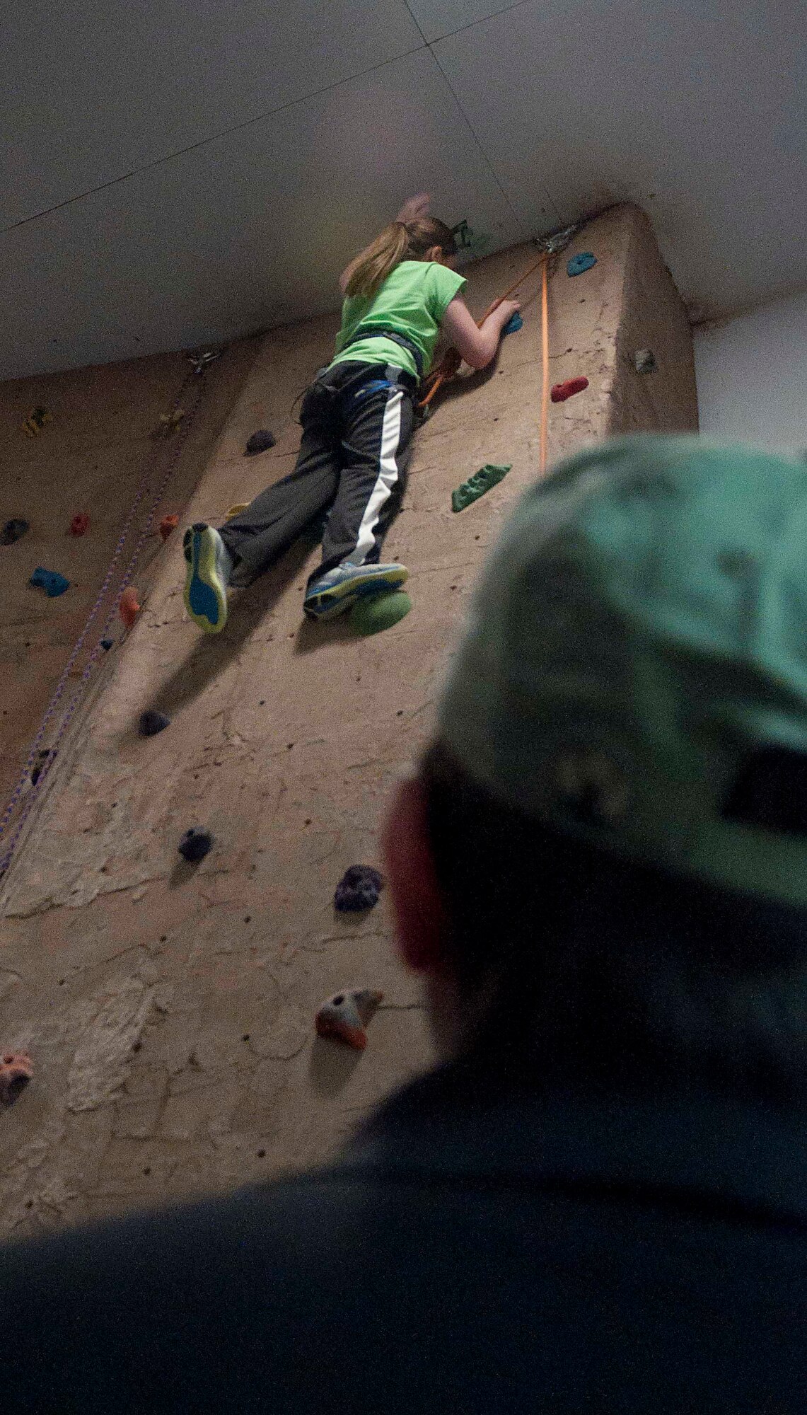 140402-F-GZ967-107 Mattie Ellsworth, 11, daughter of Lt. Col. Chad Ellsworth, 90th Logistics Readiness Squadron commander, tackles the indoor rock wall in the Fall Hall Community Center April 2 while Gus Schliffke, Outdoor Recreation employee, makes sure she is secure while she climbs. The rock wall was just one of the activities Outdoor Rec’s BRAT camp participated in over the week-long camp. (U.S. Air Force photo by Airman 1st Class Brandon Valle)