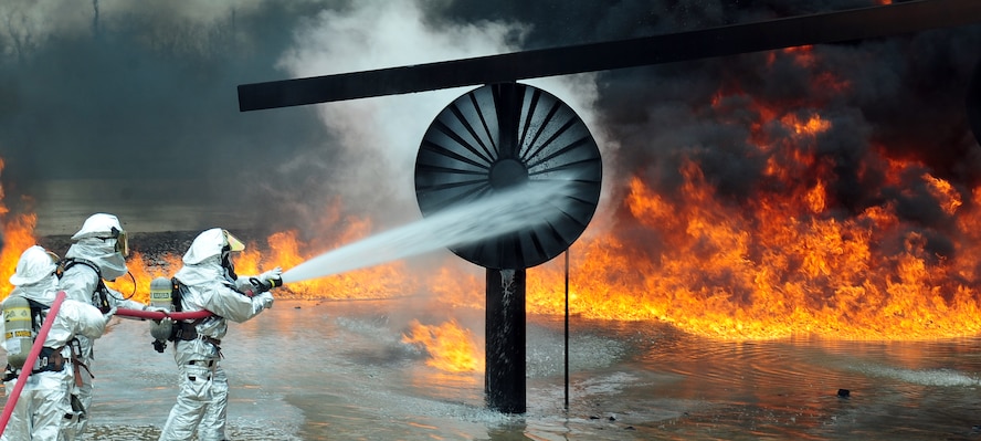 Firefighters from the Abilene Regional Airport Fire department spray water onto a fire during a live fire training exercise April 2, 2014 at Dyess Air Force Base, Texas. The usual working pressure of a fire hose can vary between 490 to 1,204 pounds per square inch. (U.S. Air Force photo by Senior Airman Kia Atkins/Released)